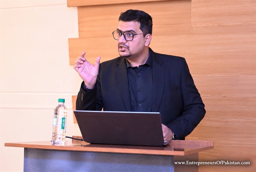 Waleed Naeem speaking during an academic session